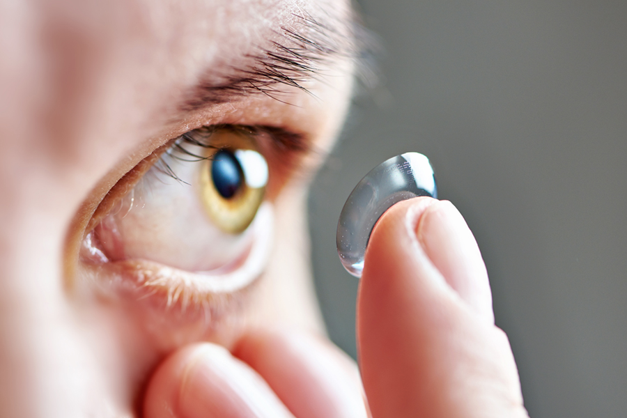 Woman putting contact lens