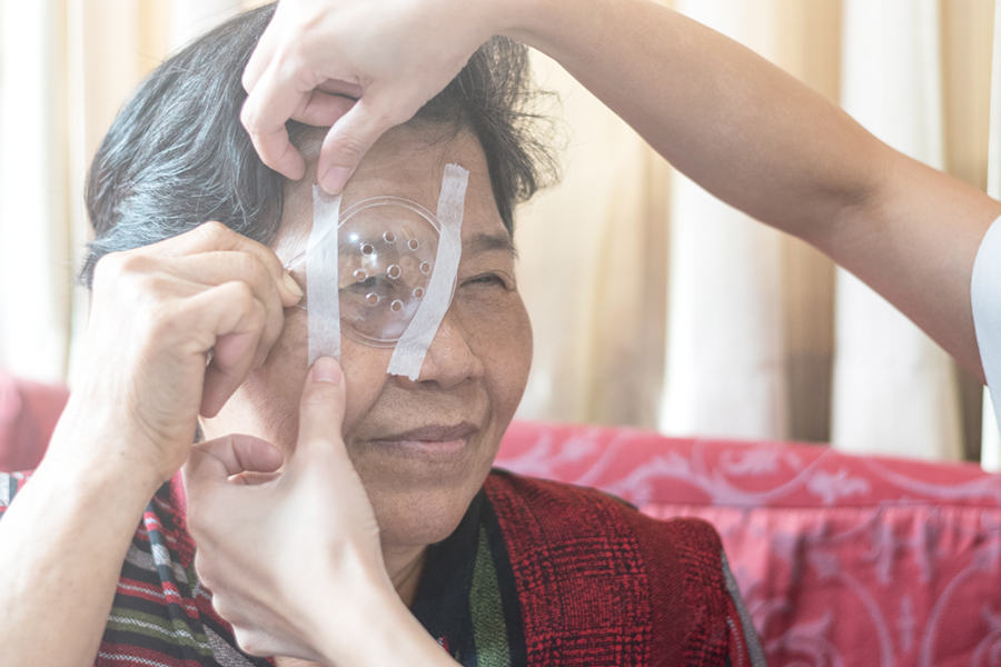 Woman wearing eye shield after cataract surgery