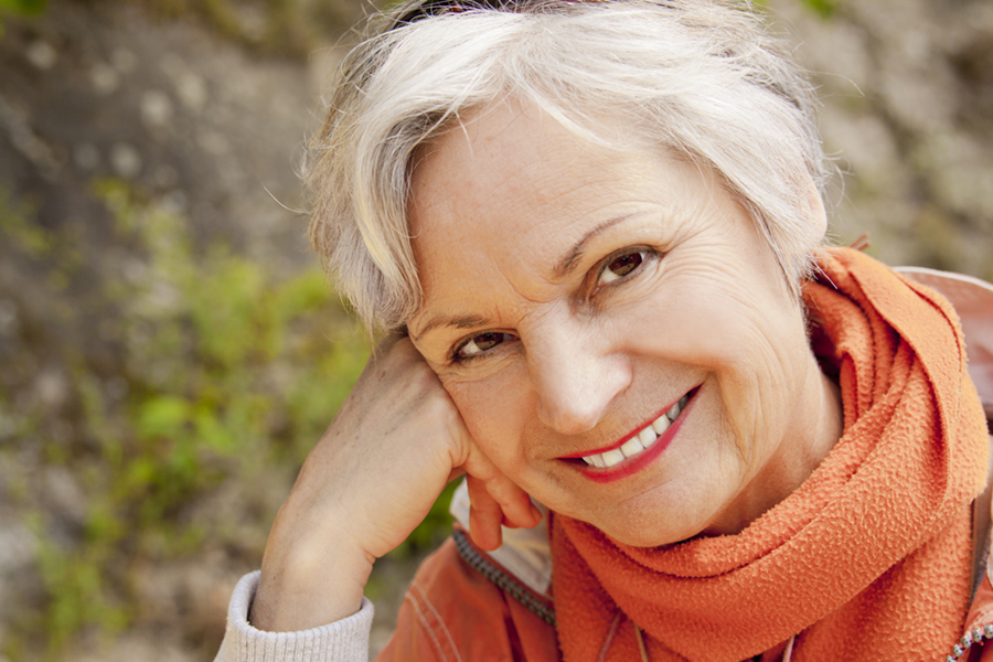 Smiling woman in her 60s outdoors
