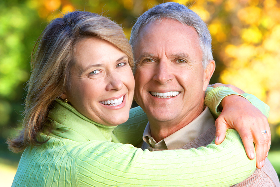 Happy elderly seniors couple in park